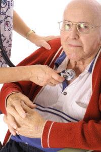 nurse checking elderly mans heart